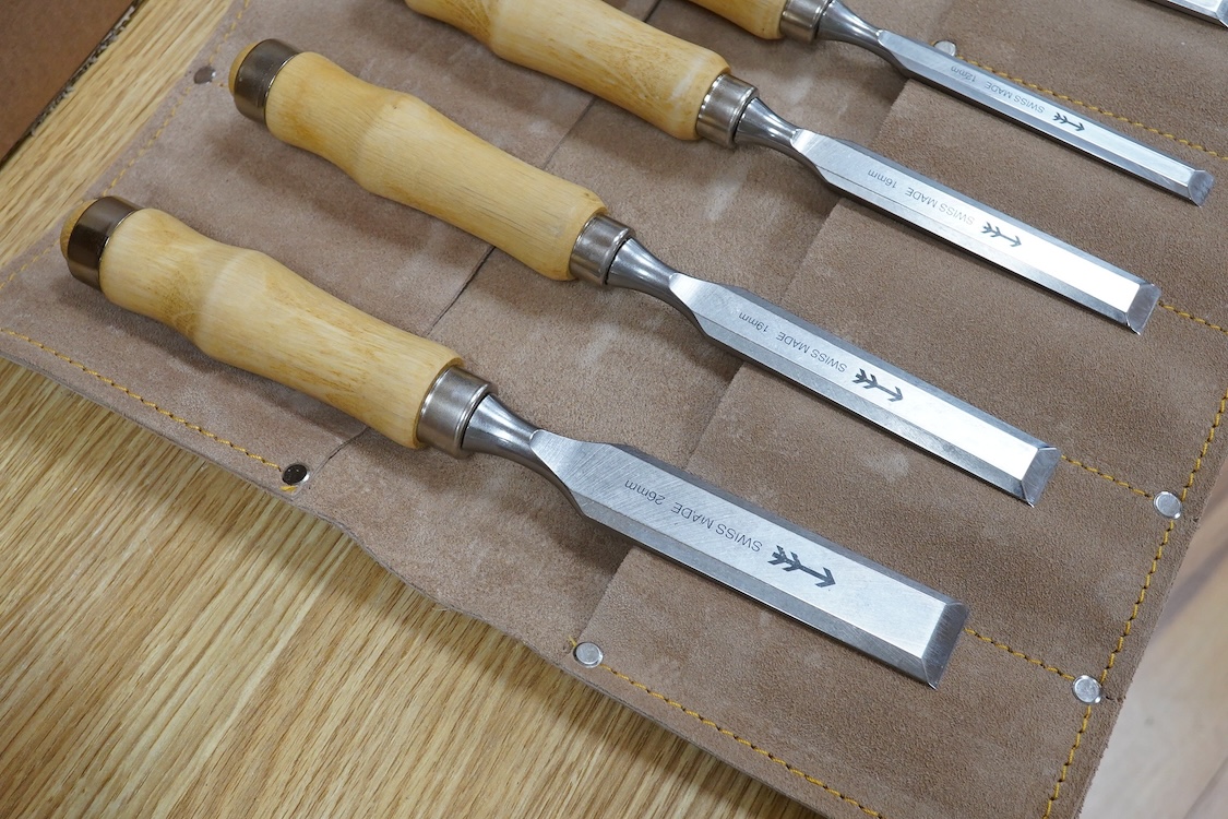 Three sets of woodworking chisels, including a cased six piece set by Seit, Germany, a nine piece set by Herschel, Germany, in a leather roll and a Swiss made nine piece set also in a leather roll